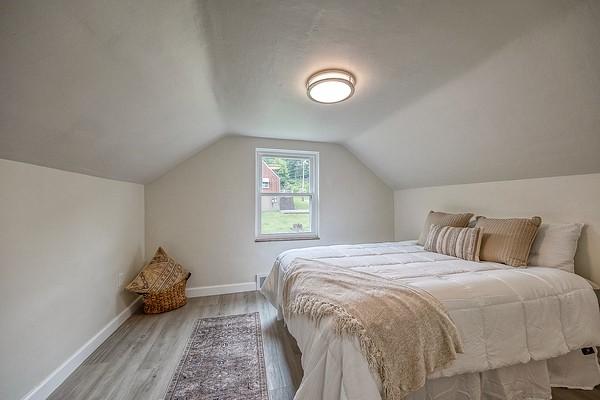1603 Randolph Ln, Penn Hills, PA 15147 - bedroom with baseboards, wood finished floors, and lofted ceiling