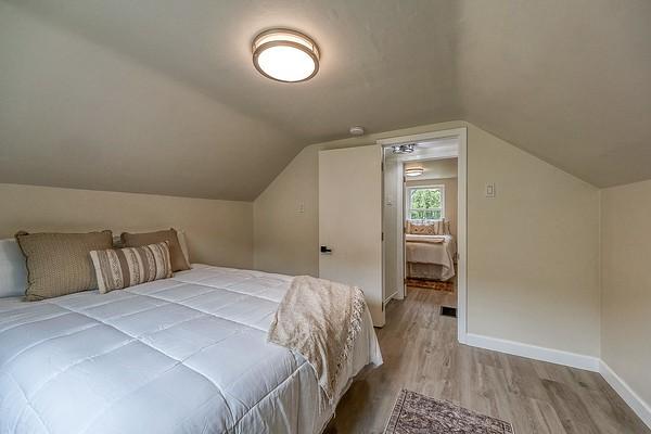 1603 Randolph Ln, Penn Hills, PA 15147 - bedroom with wood finished floors, baseboards, and vaulted ceiling