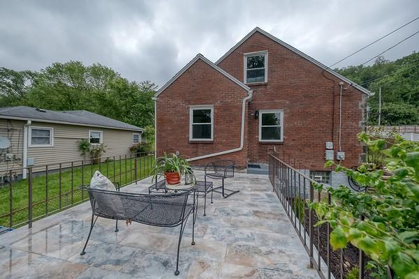 1603 Randolph Ln, Penn Hills, PA 15147 - rear view of property featuring brick siding and a patio