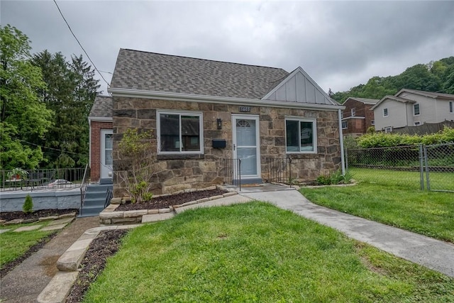 1603 Randolph Ln, Penn Hills, PA 15147 - view of front of house featuring roof with shingles, board and batten siding, and stone siding
