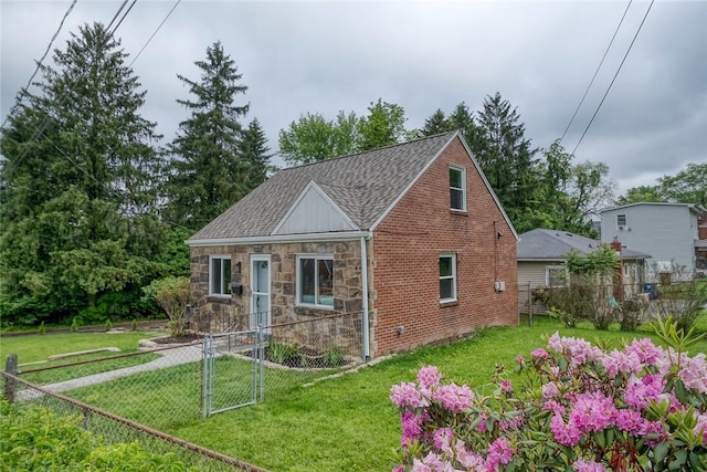 1603 Randolph Ln, Penn Hills, PA 15147 - tudor home featuring roof with shingles, stone siding, brick siding, and a gate