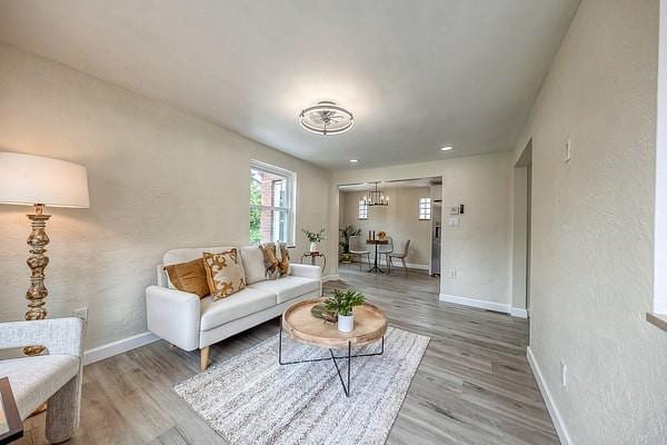 1603 Randolph Ln, Penn Hills, PA 15147 - living area with baseboards, wood finished floors, and a chandelier