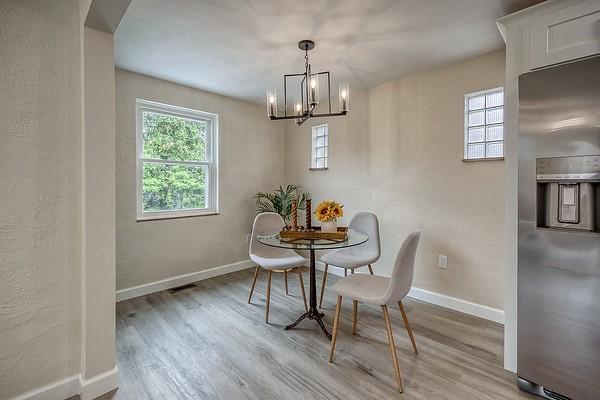 1603 Randolph Ln, Penn Hills, PA 15147 - dining room featuring wood finished floors, a chandelier, baseboards, and arched walkways