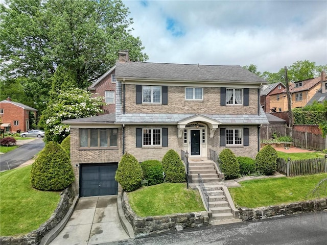7533 Graymore Rd, Point Breeze, PA 15221 - traditional-style home with a chimney, driveway, brick siding, and an attached garage