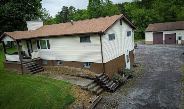 829 Saxonburg Rd, Jefferson Twp But, PA 16002 - rear view of property featuring a porch, an outbuilding, a detached garage, a chimney, and a lawn