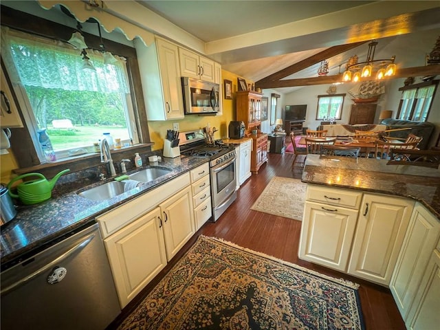 829 Saxonburg Rd, Jefferson Twp But, PA 16002 - kitchen featuring appliances with stainless steel finishes, a sink, open floor plan, dark stone countertops, and cream cabinets