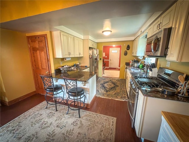 829 Saxonburg Rd, Jefferson Twp But, PA 16002 - kitchen featuring stainless steel appliances, dark wood-type flooring, a sink, baseboards, and cream cabinets