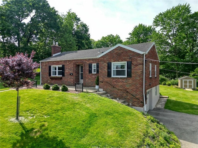 106 Richard Dr, Ross Twp, PA 15237 - ranch-style house with an attached garage, a chimney, driveway, a front lawn, and brick siding