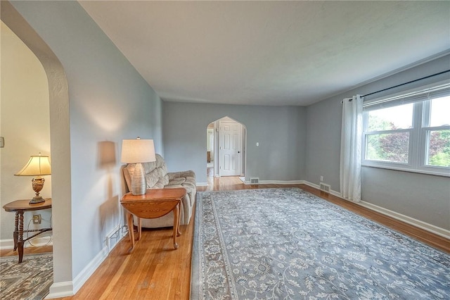 106 Richard Dr, Ross Twp, PA 15237 - living area with arched walkways, wood finished floors, and baseboards