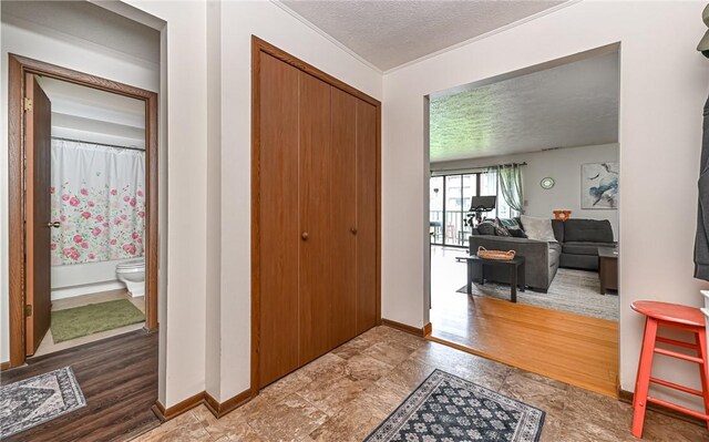 1556 Fairmont St, Wilkinsburg, PA 15221 - entrance foyer with baseboards, ornamental molding, and a textured ceiling