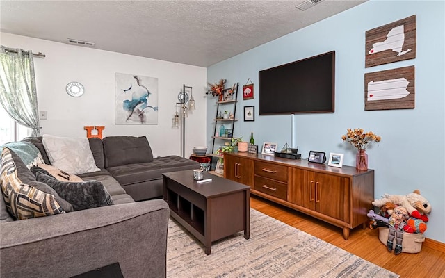 1556 Fairmont St, Wilkinsburg, PA 15221 - living room featuring light wood-style floors and a textured ceiling