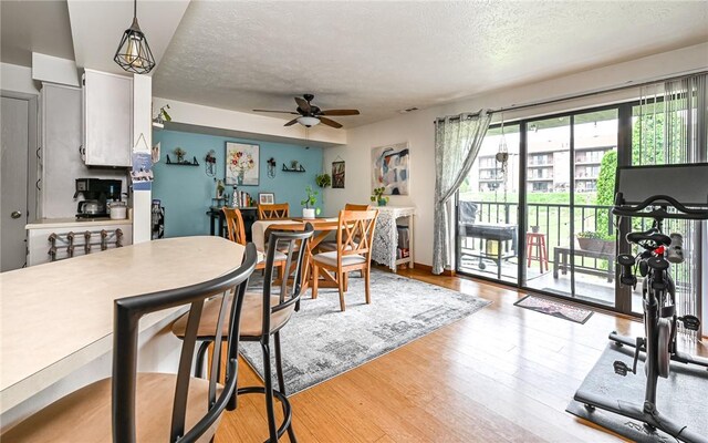 1556 Fairmont St, Wilkinsburg, PA 15221 - dining space featuring ceiling fan, a textured ceiling, and light wood-style floors