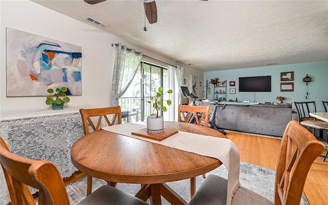 1556 Fairmont St, Wilkinsburg, PA 15221 - dining area with a ceiling fan, light wood-style floors, and a textured ceiling