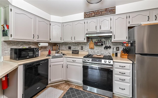 1556 Fairmont St, Wilkinsburg, PA 15221 - kitchen featuring black appliances, under cabinet range hood, a sink, and light countertops