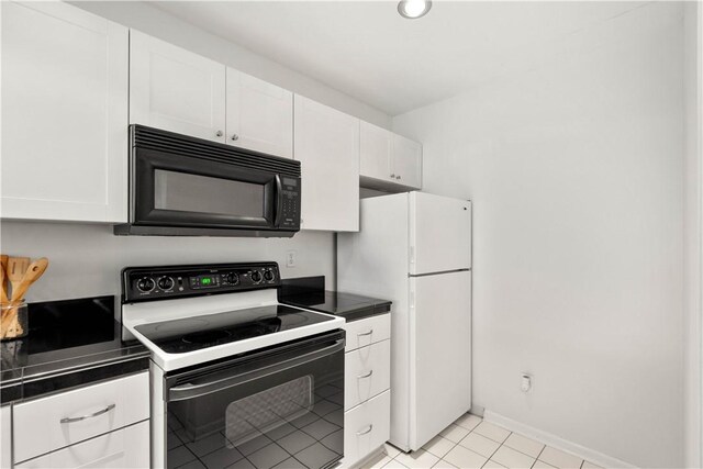 100 Denniston St Unit 211, Shadyside, PA 15206 - kitchen featuring black microwave, electric stove, dark countertops, white cabinetry, and freestanding refrigerator