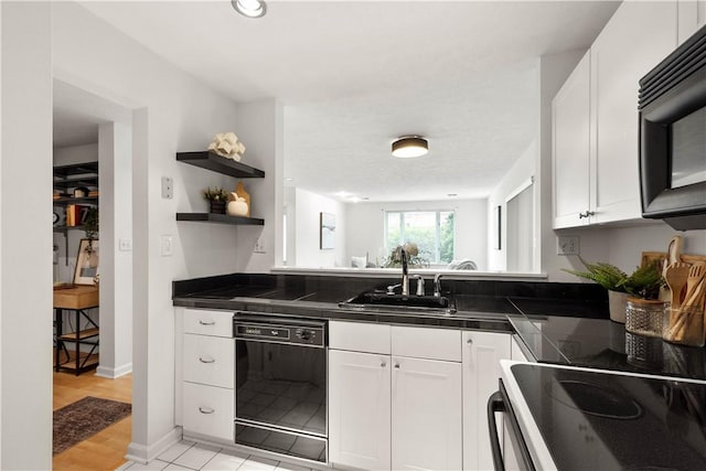 100 Denniston St Unit 211, Shadyside, PA 15206 - kitchen featuring black appliances, a sink, white cabinetry, and open shelves