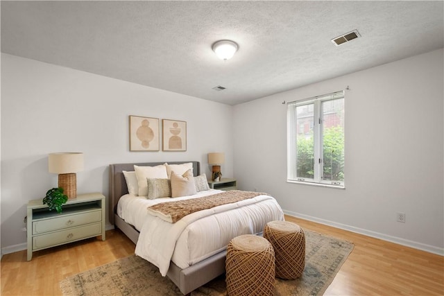 100 Denniston St Unit 211, Shadyside, PA 15206 - bedroom featuring light wood-type flooring, baseboards, and a textured ceiling