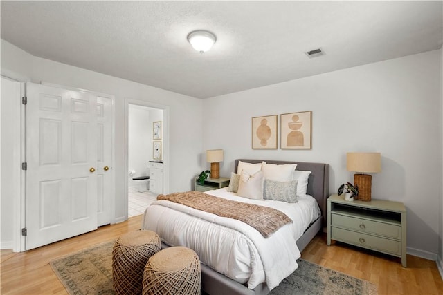 100 Denniston St Unit 211, Shadyside, PA 15206 - bedroom featuring light wood finished floors, ensuite bath, and baseboards