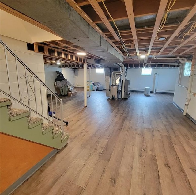 2216 Manor Dr, Manor Twp, PA 16226 - below grade area with stairs, wood finished floors, water heater, and heating unit