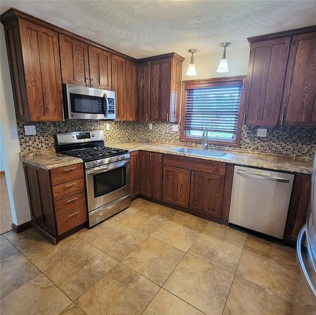 2216 Manor Dr, Manor Twp, PA 16226 - kitchen featuring appliances with stainless steel finishes, a sink, tasteful backsplash, and pendant lighting