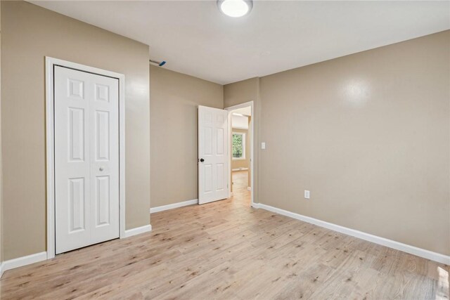 763 W Mountainview Rd, Bullskin Twp, PA 15610 - unfurnished bedroom with light wood-style floors, baseboards, and a closet