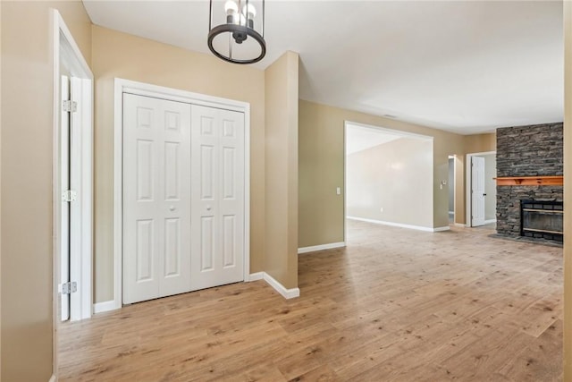 763 W Mountainview Rd, Bullskin Twp, PA 15610 - entryway featuring light wood finished floors, baseboards, a chandelier, and a fireplace