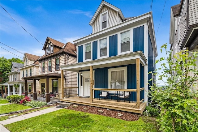 639 Tingley Ave, Bellevue, PA 15202 - american foursquare style home with covered porch, a front yard, and board and batten siding