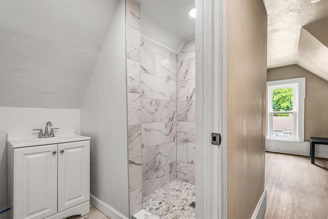 639 Tingley Ave, Bellevue, PA 15202 - full bath with vaulted ceiling, a tile shower, baseboards, and vanity