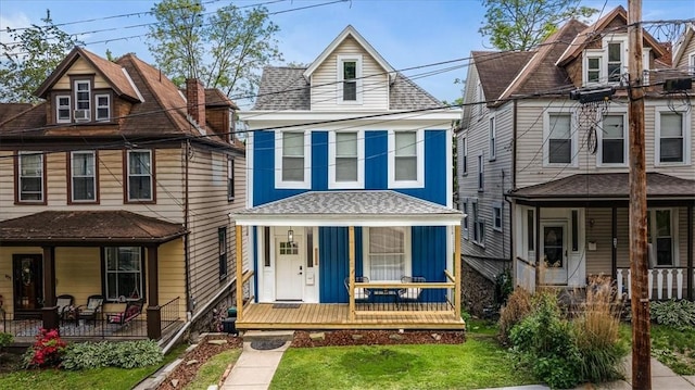 639 Tingley Ave, Bellevue, PA 15202 - view of front of property with covered porch, board and batten siding, a front lawn, and roof with shingles