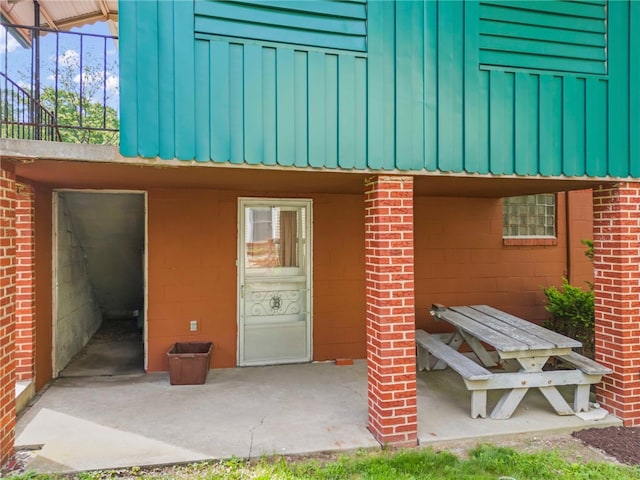 110 Steinbach Ln, Jefferson Hills, PA 15025 - view of exterior entry with a patio area, brick siding, and board and batten siding
