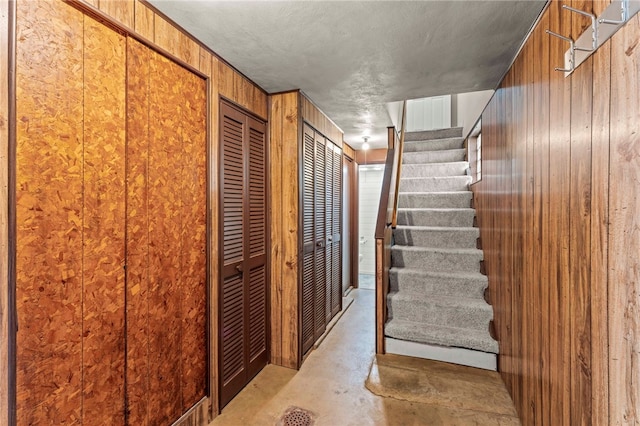 110 Steinbach Ln, Jefferson Hills, PA 15025 - stairs featuring wood walls and unfinished concrete flooring