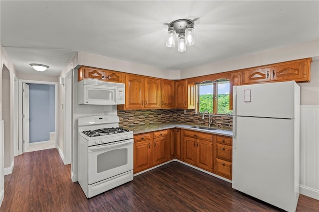 110 Steinbach Ln, Jefferson Hills, PA 15025 - kitchen with white appliances, a sink, brown cabinets, decorative backsplash, and dark wood finished floors