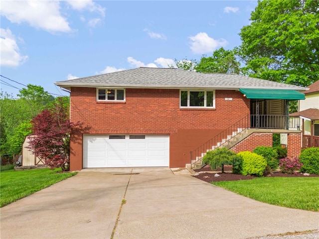 110 Steinbach Ln, Jefferson Hills, PA 15025 - view of front of home with an attached garage, concrete driveway, brick siding, and a front lawn