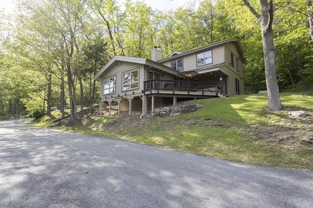2226 County Line Rd, Donegal Wml, PA 15622 - view of front of property featuring a deck, a chimney, and a front lawn