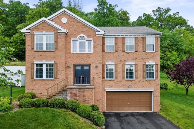 9264 Marshall, Cranberry Twp, PA 16066 - view of front of home featuring an attached garage, brick siding, asphalt driveway, and a front yard