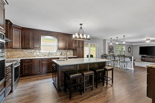 9264 Marshall, Cranberry Twp, PA 16066 - kitchen with open floor plan, dark brown cabinets, decorative backsplash, and a sink