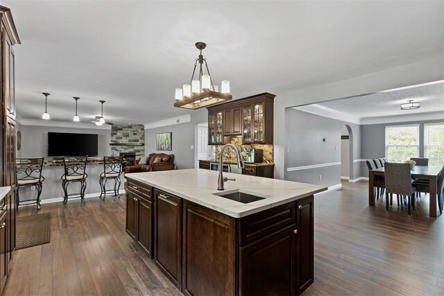 9264 Marshall, Cranberry Twp, PA 16066 - kitchen featuring a sink, open floor plan, arched walkways, backsplash, and dark wood-type flooring