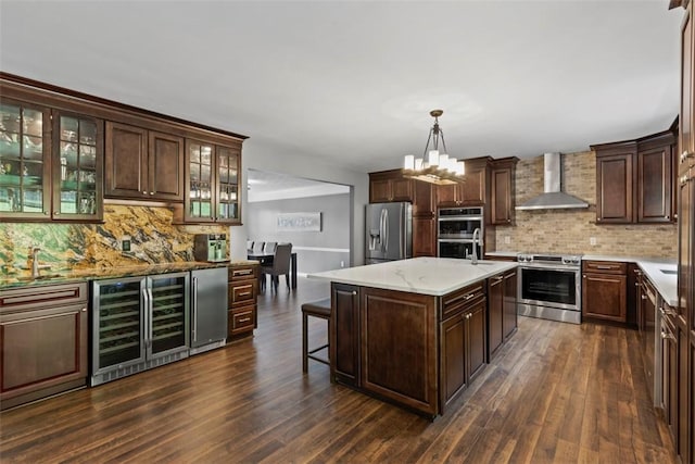 9264 Marshall, Cranberry Twp, PA 16066 - kitchen with wall chimney exhaust hood, appliances with stainless steel finishes, beverage cooler, decorative backsplash, and dark brown cabinetry
