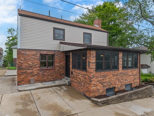 220 Cortina Way, Overbrook, PA 15234 - rear view of house featuring a chimney, brick siding, and a patio