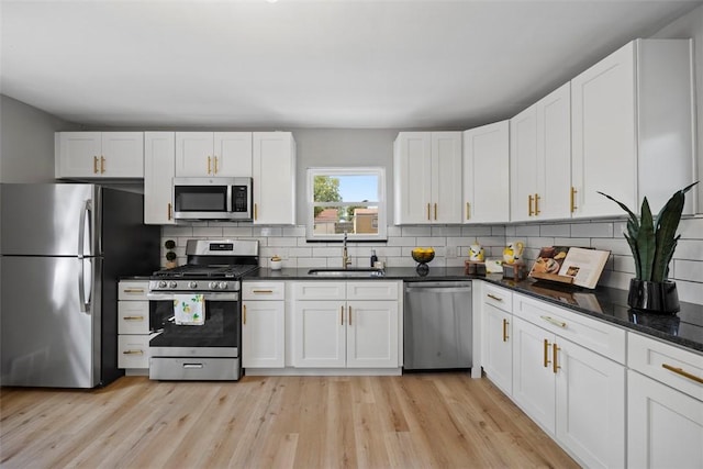 220 Cortina Way, Overbrook, PA 15234 - kitchen with stainless steel appliances, a sink, backsplash, and light wood finished floors
