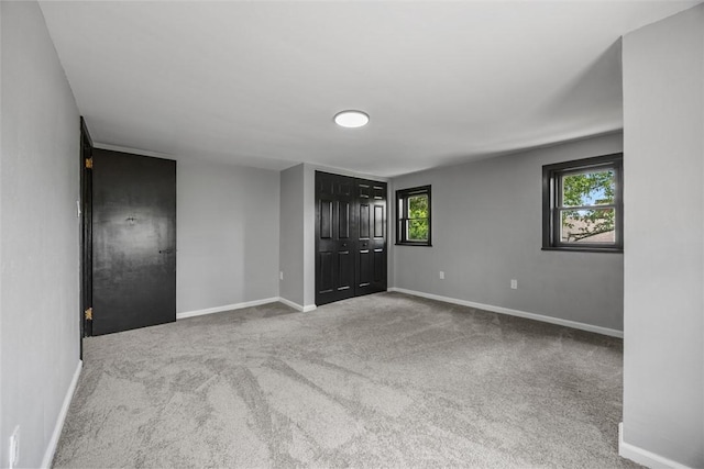 220 Cortina Way, Overbrook, PA 15234 - unfurnished bedroom with carpet, baseboards, multiple windows, and a closet
