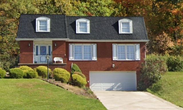 110 Ardennes Ct, Trafford, PA 15085 - view of front facade featuring a garage, a front yard, brick siding, and concrete driveway