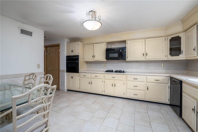 110 Ardennes Ct, Trafford, PA 15085 - kitchen with black appliances, light countertops, cream cabinets, and glass insert cabinets