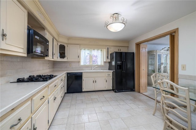 110 Ardennes Ct, Trafford, PA 15085 - kitchen with black appliances, light countertops, a sink, and tasteful backsplash