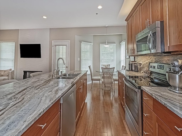 824 Kingsberry Cir, Mt Lebanon, PA 15234 - kitchen with appliances with stainless steel finishes, a sink, dark wood-style flooring, brown cabinetry, and open floor plan