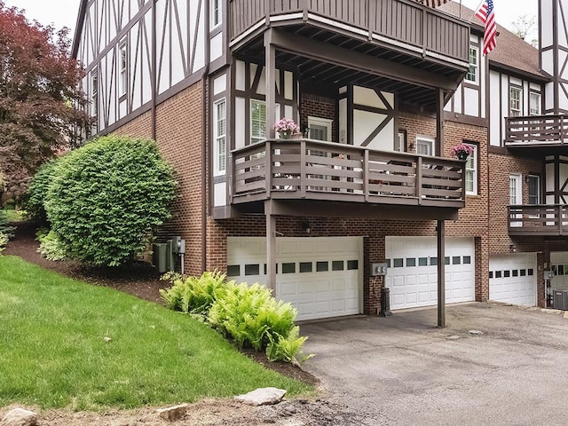824 Kingsberry Cir, Mt Lebanon, PA 15234 - back of house with brick siding, an attached garage, driveway, a balcony, and cooling unit