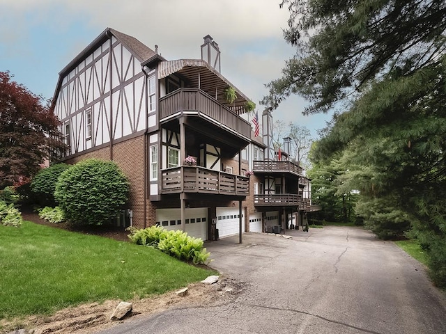 824 Kingsberry Cir, Mt Lebanon, PA 15234 - view of front of property featuring a balcony, a garage, brick siding, a front yard, and a chimney
