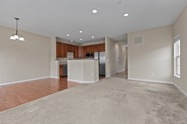 190 Southern Valley Ct, Adams Twp, PA 16046 - unfurnished living room featuring light colored carpet, baseboards, a chandelier, and recessed lighting