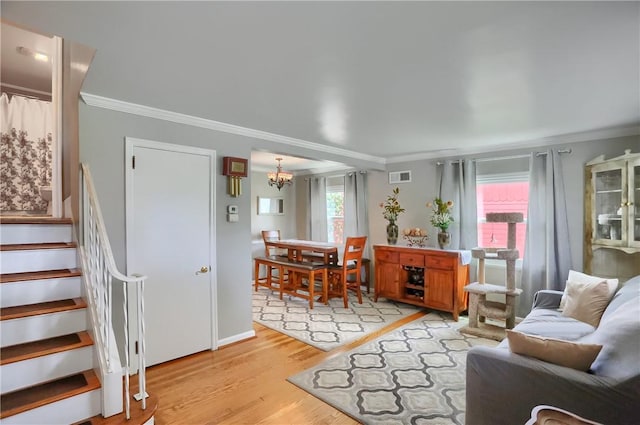 304 Petain St, Ellwood City Law, PA 16117 - living area featuring crown molding, light wood-style flooring, a chandelier, stairway, and baseboards