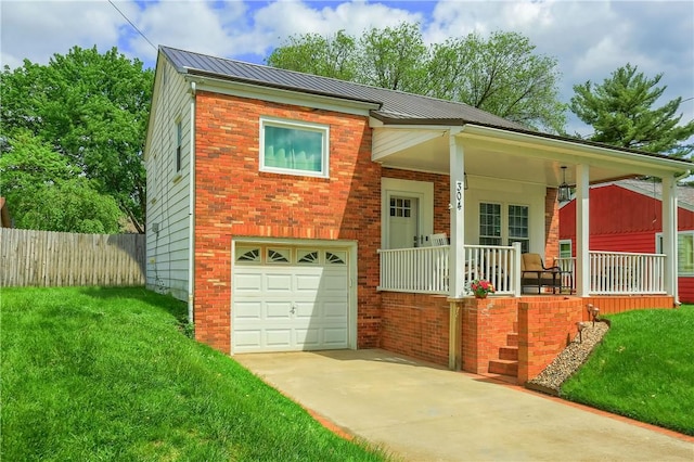 304 Petain St, Ellwood City Law, PA 16117 - view of front of home with covered porch, an attached garage, driveway, brick siding, and metal roof